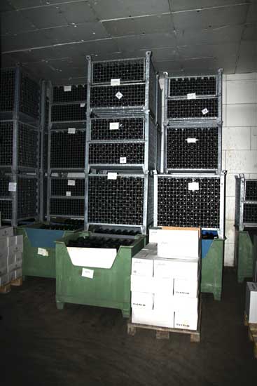 Unlabelled wines stored in barred boxes